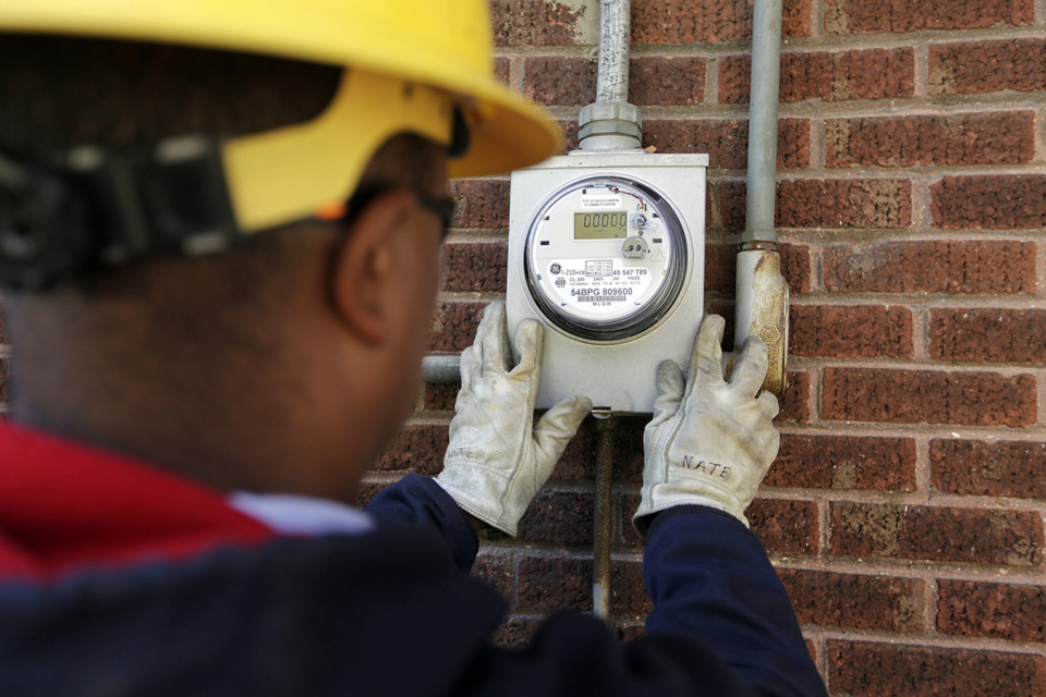 <strong>Nate Guyton of Memphis Light, Gas and Water installs a smart meter on a house in the Cooper-Young neighborhood.&nbsp;</strong>(Lance Murphey/The Daily Memphian file)