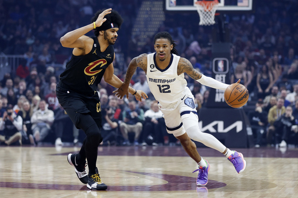 <strong>Memphis Grizzlies guard Ja Morant (12) drives against Cleveland Cavaliers center Jarrett Allen (31) during the first half of an NBA basketball game on Feb. 2 in Cleveland.</strong> (Ron Schwane/AP Photo)