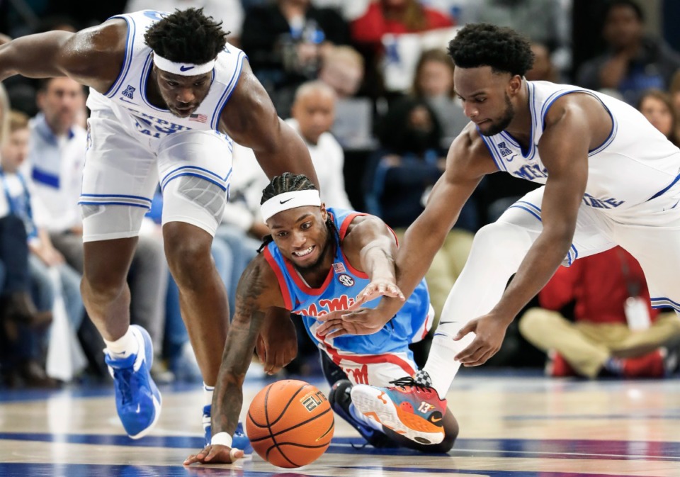 <strong>Memphis Tigers teammates Malcolm Dandridge (left) and Alex Lomax (right) battle Ole Miss guard Amaree Abram (middle) for a loose ball on Saturday Dec. 3, 2022.</strong> (Mark Weber/The Daily Memphian file)