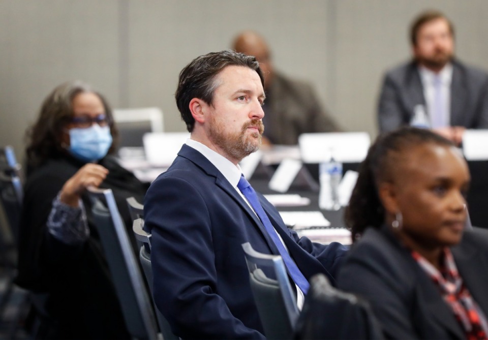 <strong>County Commissioner Mick Wright (middle) attends a consolidation discussion with council members and county commissioners on Thursday, Dec. 9, 2021 at the Renasant Convention Center.</strong> (Mark Weber/The Daily Memphian file)