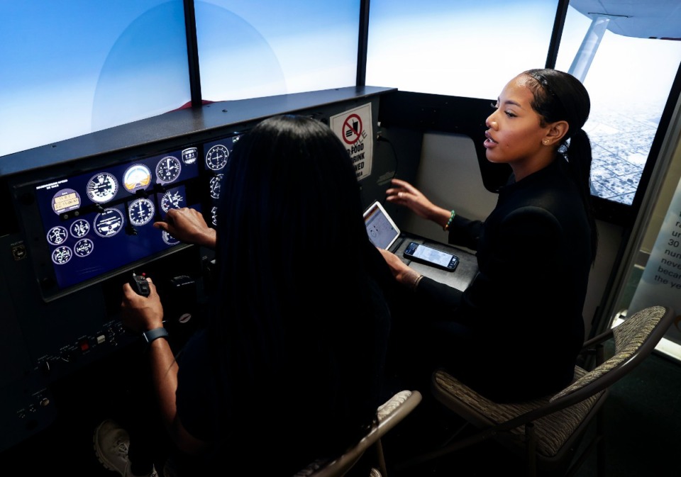 <strong>Luke Weathers Flight Academy instructor Zakiya Percy (right) uses a flight simulator to work with student Carlin Bratcher (left) on Wednesday, February 8, 2023 at the Olive Branch Airport.</strong> (Mark Weber/The Daily Memphian)