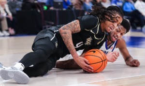 Memphis guard Elijah McCadden (0) dives for a loose ball during a Feb. 16, 2023 game against UCF. (Patrick Lantrip/The Daily Memphian)