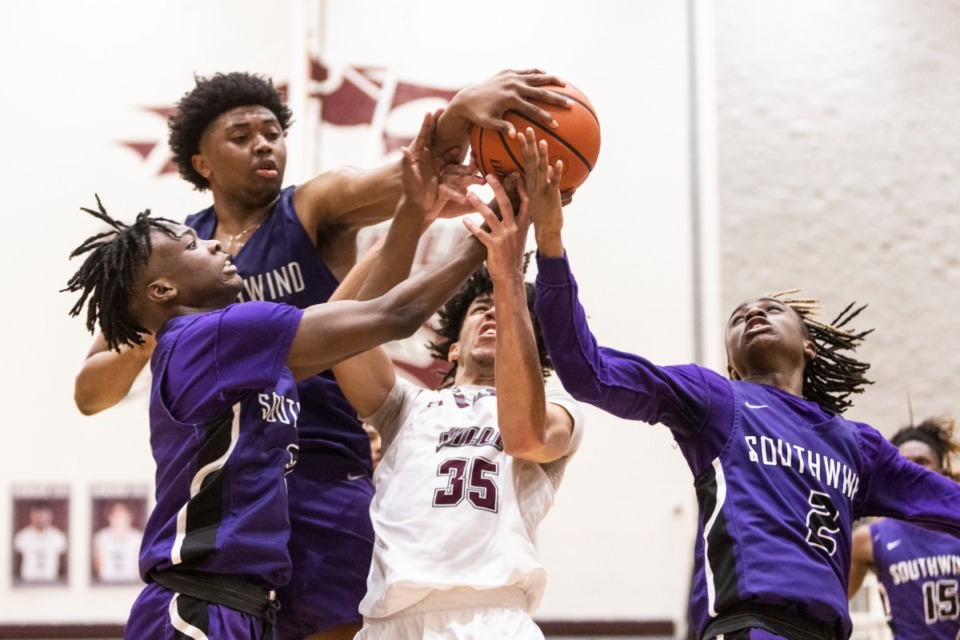 <strong>Collierville&rsquo;s T.J. Thompson, middle, battles Southwind for the ball during the title game of the 15-AAAA tournament between Southwind and Collierville.</strong>&nbsp;(Brad Vest/Special to The Daily Memphian)