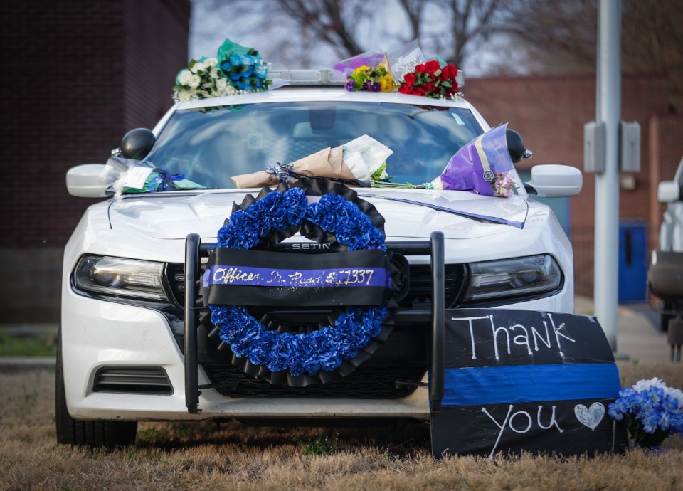 <strong>A squad car is parked in front of the Appling Farms precinct for community members to bring cards and flowers in memory of slain officer Geoffrey Redd.</strong> (Patrick Lantrip/The Daily Memphian)