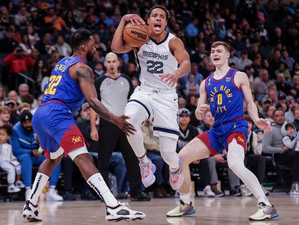 <strong>Grizzlies guard Desmond Bane (22) splits two defenders during a Feb. 25, 2023 game against the Denver Nuggets.</strong> (Patrick Lantrip/The Daily Memphian)