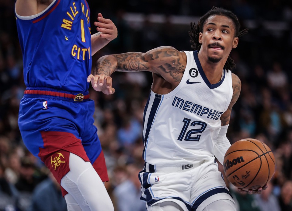<strong>Grizzlies guard Ja Morant (12) drives to the basket during a Feb. 25, 2023 game against the Denver Nuggets.</strong> (Patrick Lantrip/The Daily Memphian)