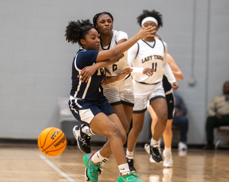 <strong>Whitehaven's La'Niyah Moore (middle) knocks the ball away from Arlington&rsquo;s Brittani Wells in the Region 8 Class 4A semifinals, Monday, Feb. 27, 2023, at Houston High School. Arlington was defeated by Whitehaven 52-51. </strong>(Greg Campbell/Special to The Daily Memphian)