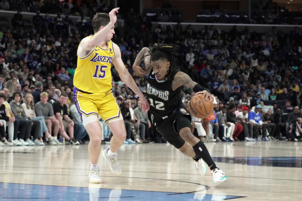 <strong>Memphis Grizzlies Ja Morant (12) drives to the basket against Los Angeles Lakers Austin Reaves (15) on Feb. 28, 2023. Morant put on a clinic in the third quarter, scoring 28 points in that quarter alone.</strong> (Karen Pulfer Focht/AP)