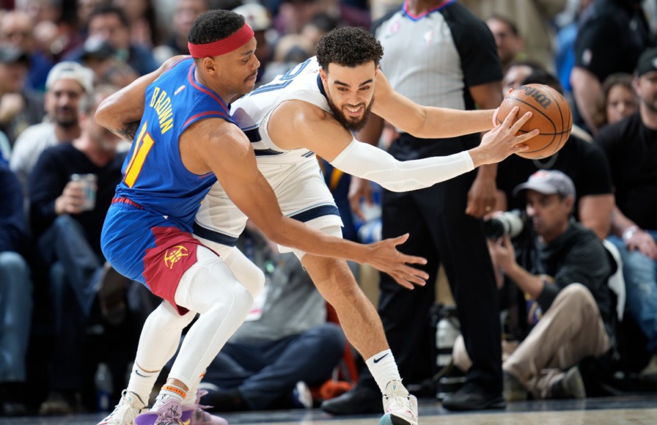 <strong>Memphis Grizzlies guard Tyus Jones, right, looks to pass the ball as Denver Nuggets forward Bruce Brown defends on March 3, 2023, in Denver.</strong> (David Zalubowski/AP)