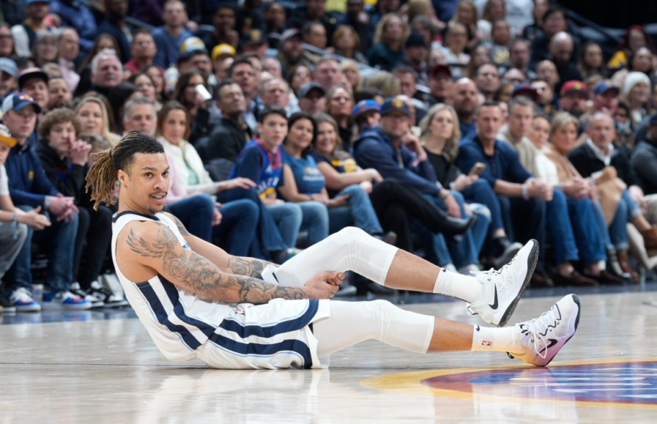 <strong>Memphis Grizzlies forward Brandon Clarke holds his leg after he was injured in the game against the Denver Nuggets, Friday, March 3, 2023, in Denver.</strong> (David Zalubowski/AP)