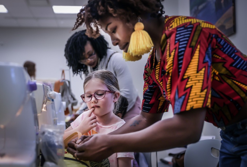 <strong>Artist Samilia teaches Corinne Fletcher how to make a handmade purse during an interactive portion of the third annual Women in the Arts Festival at the Dixon March 3, 2023.</strong> (Patrick Lantrip/The Daily Memphian)