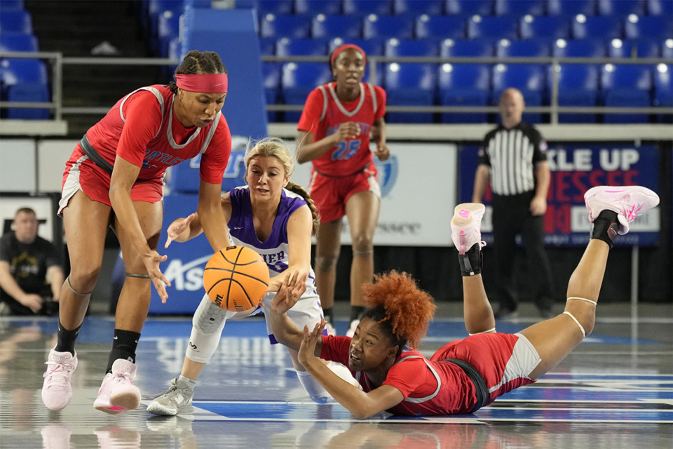 <strong>Barlett&rsquo;s Carrington Jones, right, passes the ball to Raven Sims, left, as Sevier County&rsquo;s Kinley Loveday, center, defends during the first half of a Class 4A game in the TSSAA BlueCross girls&rsquo; state basketball tournament March 7 in Murfreesboro, Tenn.</strong> (Mark Humphrey/Special to The Daily Memphian)