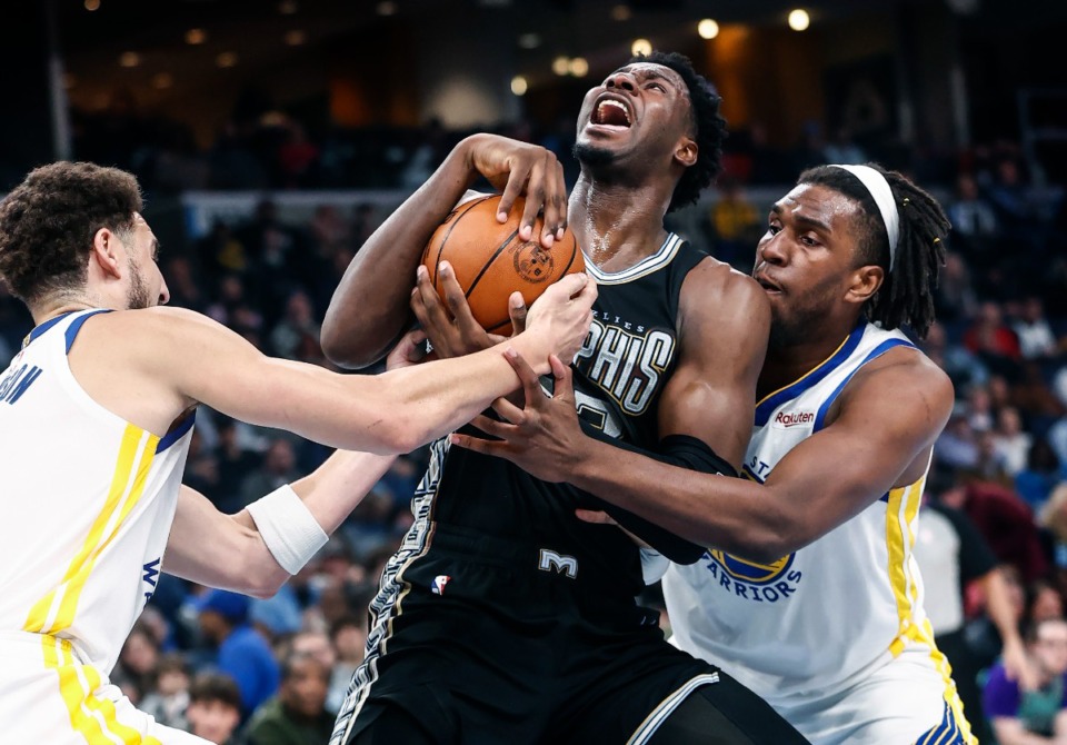 <strong>Memphis Grizzlies forward Jaren Jackson Jr., (middle) battles Golden State Warriors defenders Klay Thompson (left) and Kevon Looney (right) on Thursday, March 9, 2023.</strong> (Mark Weber/The Daily Memphian file)