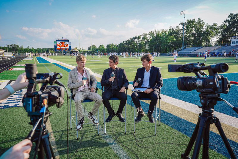 <strong>Arlington High School students Brent Lyons (left) Adian Hurst-Vasquez and Jake Stoope live stream from a sports event.</strong> (Courtesy Arlington High)