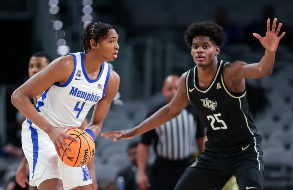 <strong>Memphis forward Chandler Lawson (4) looks for an open teammate while being guarded by UCF forward Taylor Hendricks (25) on March 10, 2023.</strong> (Patrick Lantrip/The Daily Memphian)