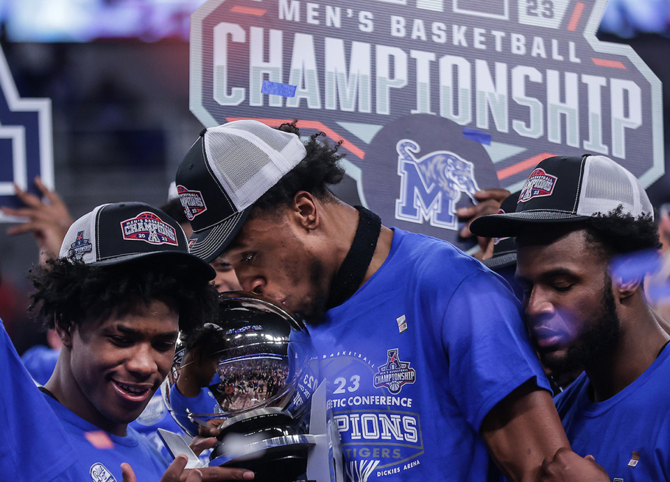 <strong>University of Memphis forward DeAndre Williams kisses the AAC Championship trophy after defeating Houston in the AAC Championship game March 12, 2023.</strong> (Patrick Lantrip/The Daily Memphian)