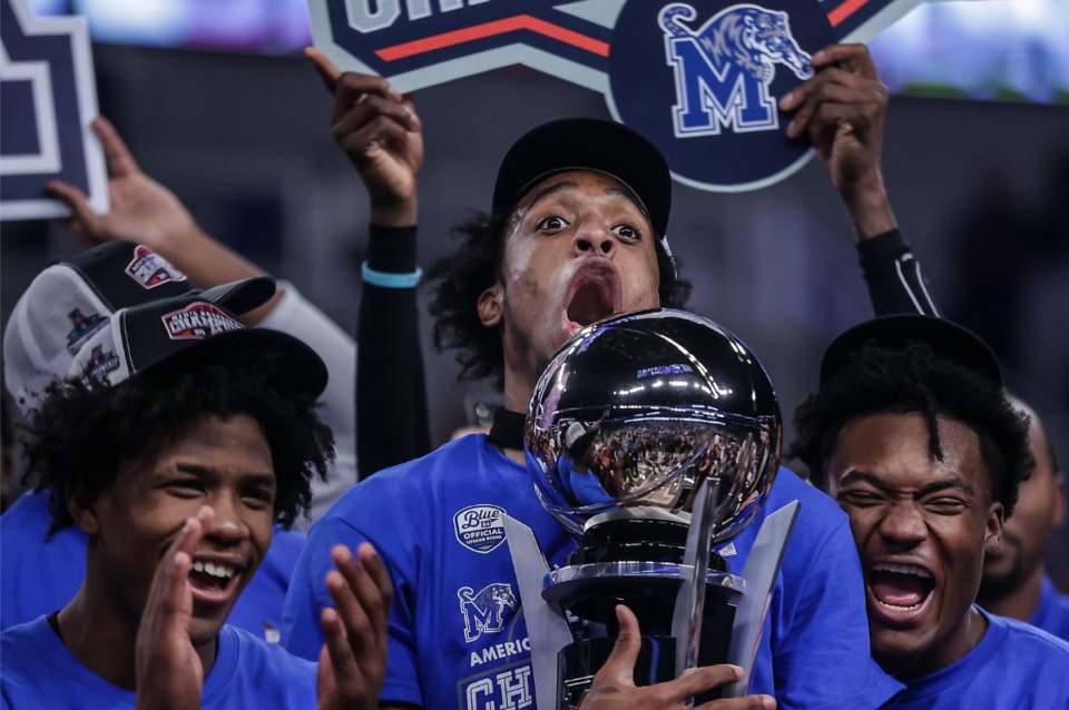 <strong>University of Memphis forward Deandre Williams reacts to being handed the AAC Championship trophy after defeating Houston on March 12, 2023.&nbsp;It was the first time to win the championship since joining the conference in 2013, and the Tigers had to beat the No. 1 team to do it.</strong> (Patrick Lantrip/The Daily Memphian file)