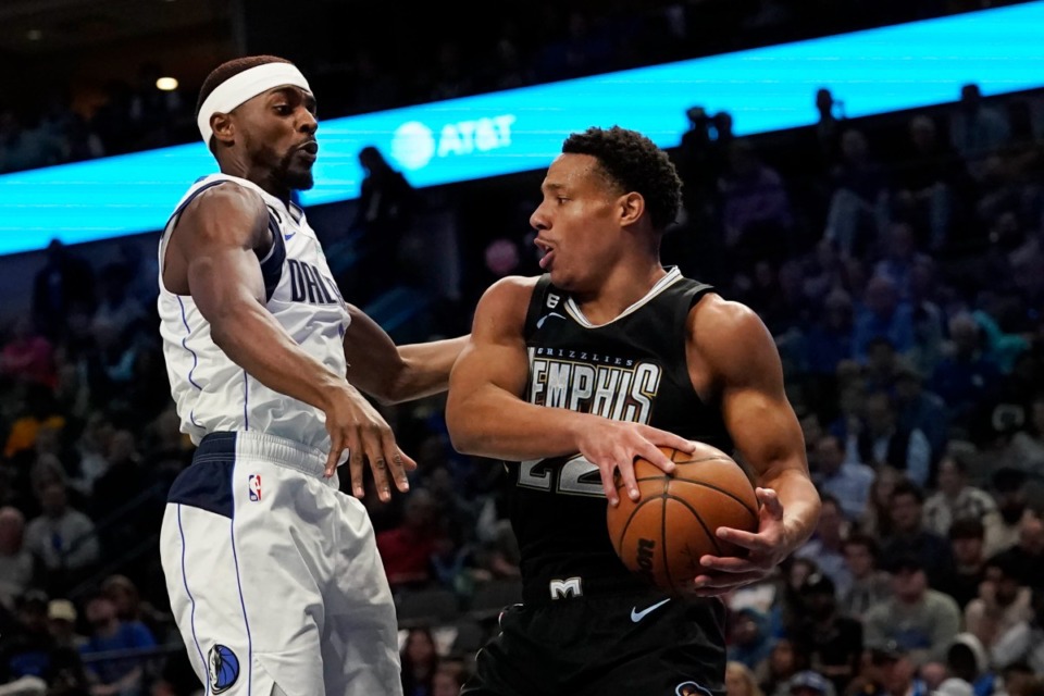 <strong>Memphis Grizzlies guard Desmond Bane (22) grabs a rebound against Dallas Mavericks forward Justin Holiday on March 13, 2023. Bane finished with 23 points.</strong>&nbsp;(LM Otero/AP)
