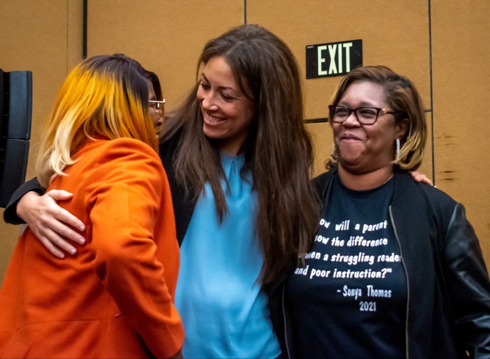 <strong>Schwinn embraces Renee Smith (left) and Sonya Thomas (right). Schwinn spoke of her childhood Saturday, saying that the only difference between her and kids she grew up with was her reading ability.</strong> (Aarron Fleming/The Daily Memphian)
