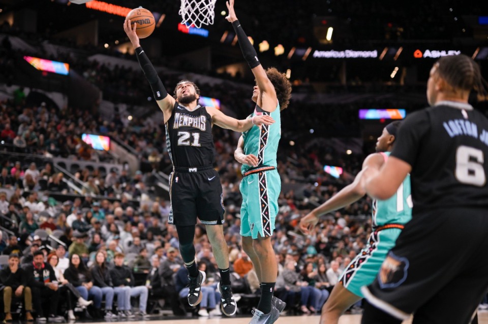 <strong>Memphis Grizzlies' Tyus Jones (21) goes to the basket against San Antonio Spurs' Dominick Barlow, on his way to a triple double in the Grizzlies&rsquo; comeback win on March 17, 2023, in San Antonio.</strong> (Darren Abate/AP)