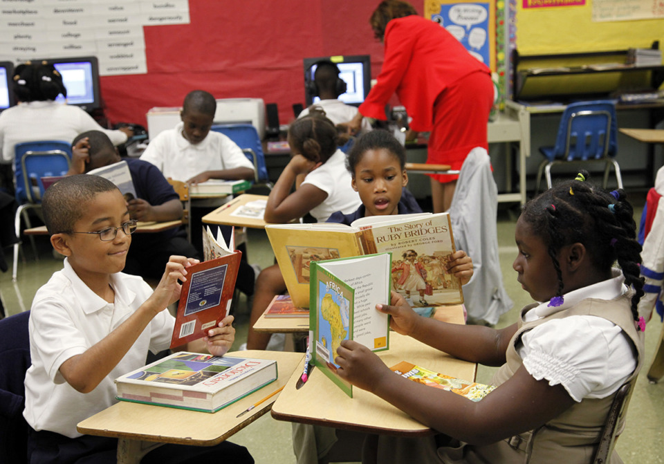 <strong>From left, Gardenview Elementary School third graders Elwood Cooper, Destiny Crawford and Alandance Robertson read books during a Read for the Record program.</strong> (Lance Murphey/The Daily Memphian file)