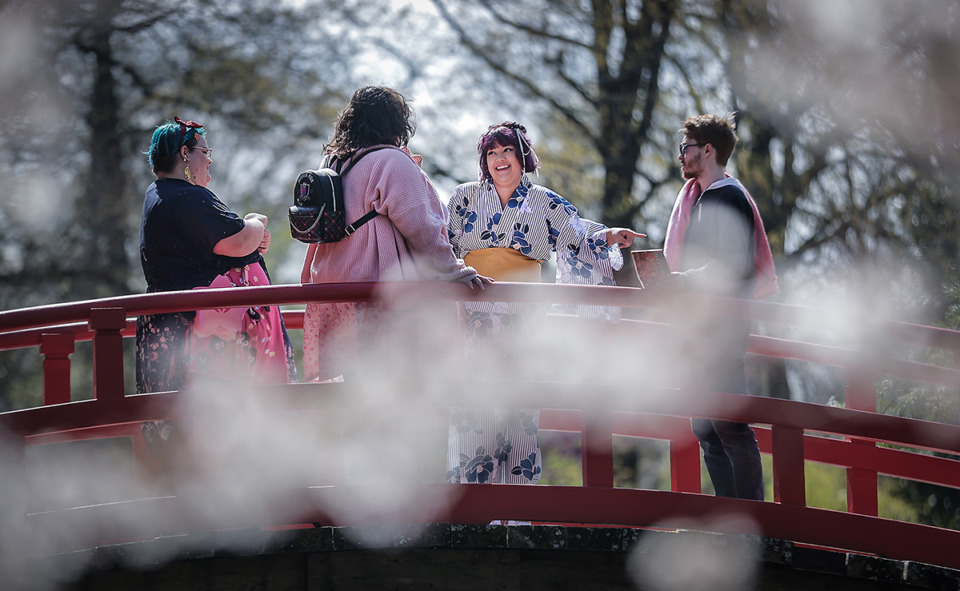 <strong>Christina Barber (center) meets up with friends while during the Memphis Botanic Garden's Cherry Blossom Picnic March 18, 2023.</strong> (Patrick Lantrip/The Daily Memphian)