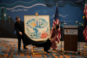 <strong>Kong Wee Pang (right) helps reveal the Memphis in May International Festival's 2023 annual poster, which she created.</strong> (Credit Ally Perkins)