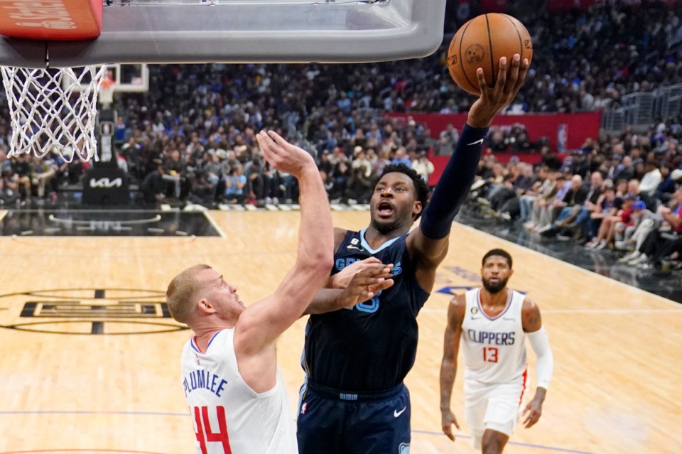 <strong>Memphis Grizzlies forward Jaren Jackson Jr. (middle) shoots over Los Angeles Clippers center Mason Plumlee (left) and forward Paul George on March 5 in Los Angeles.</strong> (Mark J. Terrill/AP file)