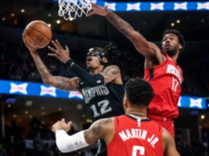 <strong>Memphis Grizzlies guard Ja Morant (left) drives to the basket against Houston Rockets defenders Tari Eason (right) and Kenyon Martin Jr. (bottom) on Friday, March 24, 2023.</strong> (Mark Weber/The Daily Memphian)