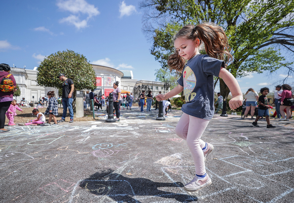 <strong>Bradley Clark, 5, plays hopscotch at the Brooks Museum's Chalkfest March 25, 2023.</strong> (Patrick Lantrip/The Daily Memphian)