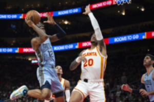 <strong>Memphis Grizzlies guard Ja Morant (12) shoots against Atlanta Hawks forward John Collins (20) during the first half of an NBA basketball game March 26 in Atlanta.</strong> (Hakim Wright Sr./AP Photo)