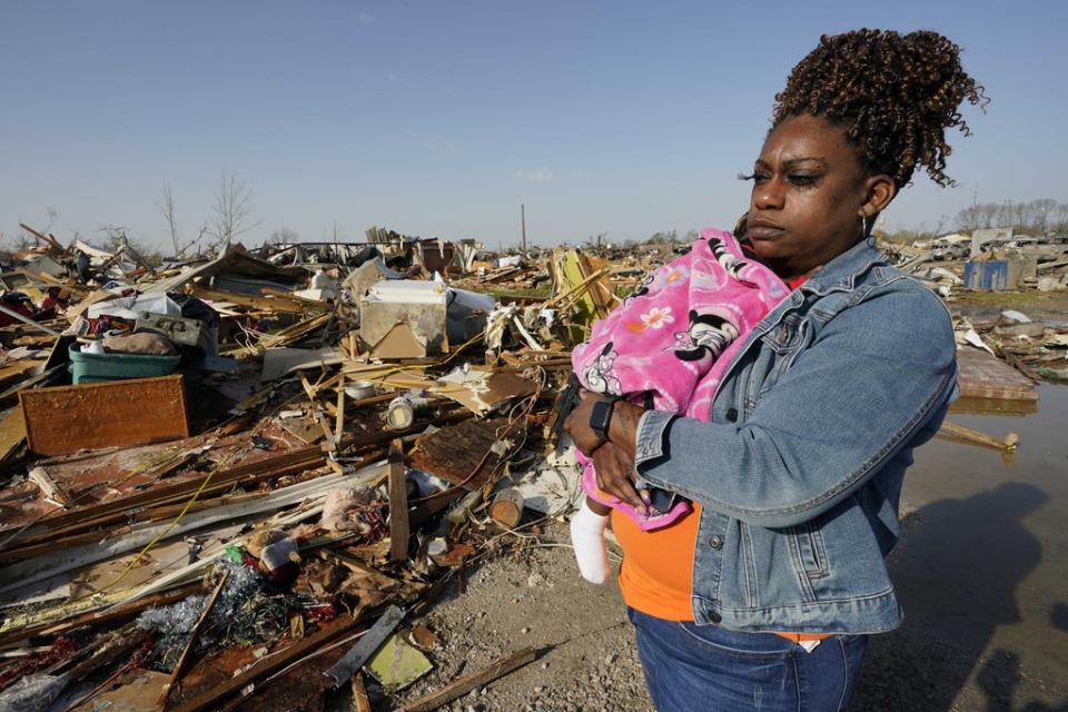 <strong>Wonder Bolden cradles her year-old granddaughter Journey Bolden as she surveys the remains of her mother's mobile home in Rolling Fork, Mississippi, which was demolished by a tornado on Friday, March 24, 2023.</strong> (Rogelio V. Solis/AP file)