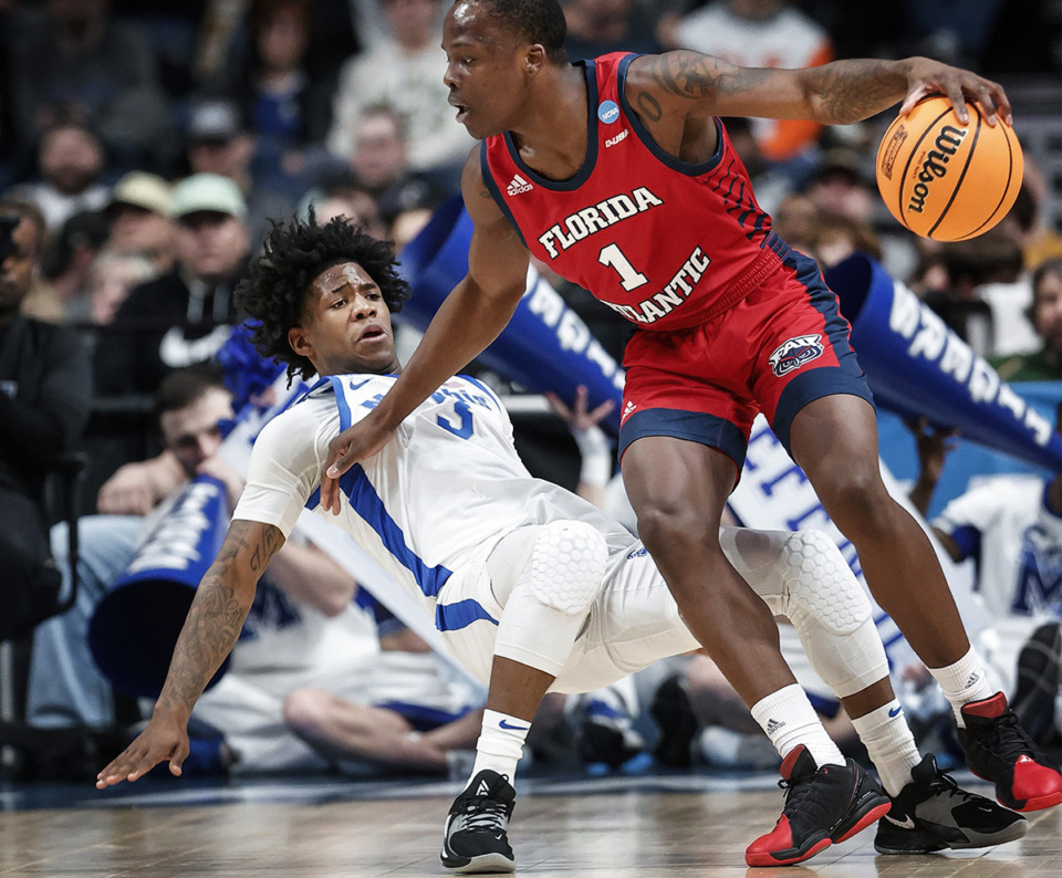 <strong>University of Memphis defender Kendric Davis takes a charging foul against Florida Atlantic University guard Johnell Davis (right) during action in their NCAA tournament game March 17 in Columbus, Ohio.</strong> (Mark Weber/The Daily Memphian)