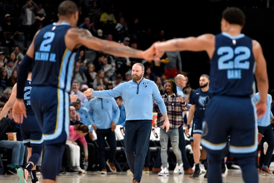 <strong>Memphis Grizzlies forward Xavier Tillman (2) and guard Desmond Bane (22) give each other five as head coach Taylor Jenkins walks on the court during a timeout on March 28, 2023.</strong> (Brandon Dill/AP)