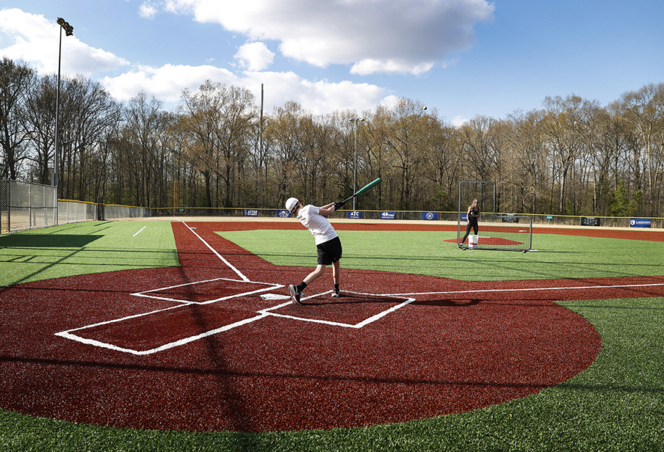 <strong>Wilson Wheat, 13, takes batting practice with his mother Emily Wheat on the new turf baseball fields at Cameron Brown Park on Tuesday, March 28, 2023 in Germantown.</strong> (Mark Weber/The Daily Memphian)