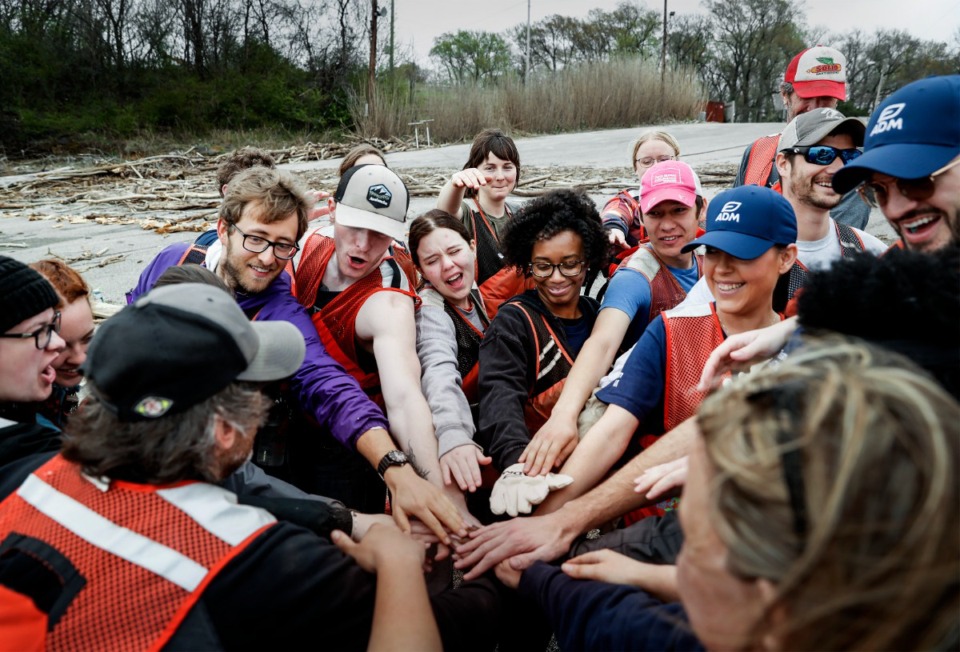 <strong>College students and volunteers from Archer-Daniels-Midland Company huddle together before cleaning trash on the banks of McKellar Lake, with help from Living Lands &amp; Waters on Thursday, March 23, 2023.</strong> (Mark Weber/The Daily Memphian)