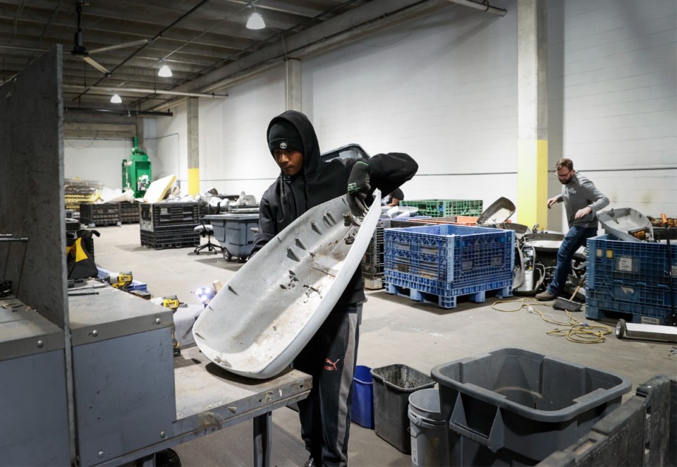 <strong>Kevin Martin disassembles a streetlight at The Binghampton Development Corp. on Thursday, March 30, 2023, that will be recycled for parts and scrap metal.</strong> (Mark Weber/The Daily Memphian)