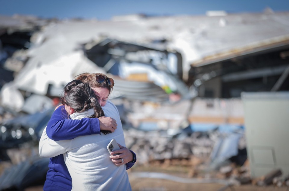 <strong>Crestview Elementary School teachers Anna Vandiver (left) and Elizabeth Woddell share a tearful hug while visiting the mangled wreckage of their classrooms April 1, 2023, after a tornado ripped through the town of Covington the night before.</strong> (Patrick Lantrip/The Daily Memphian)