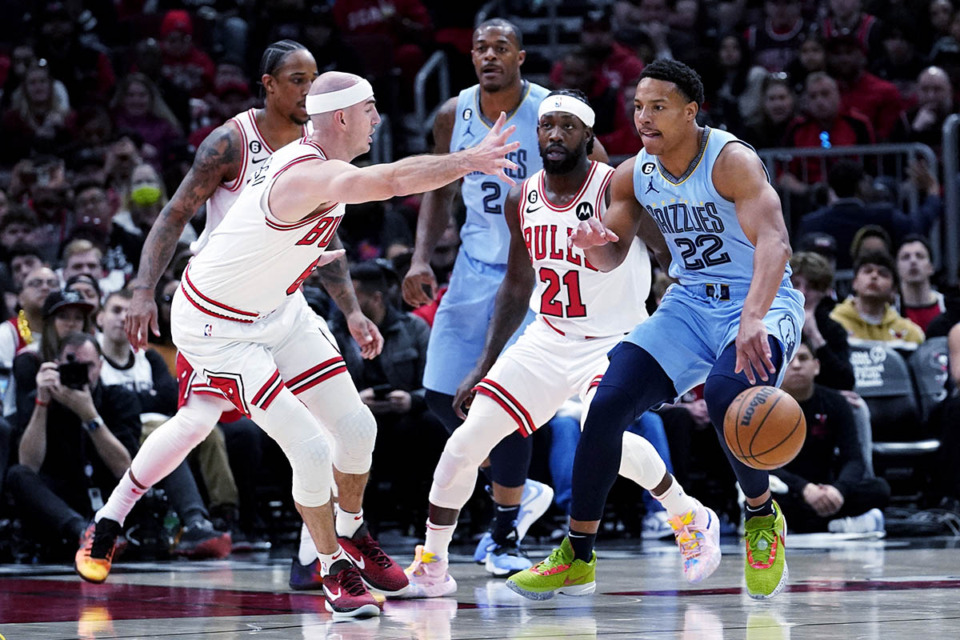 <strong>Memphis Grizzlies guard Desmond Bane (22) drives as Chicago Bulls guard Alex Caruso (left) guards during the game in Chicago April 2.</strong> (Nam Y. Huh/AP Photo)