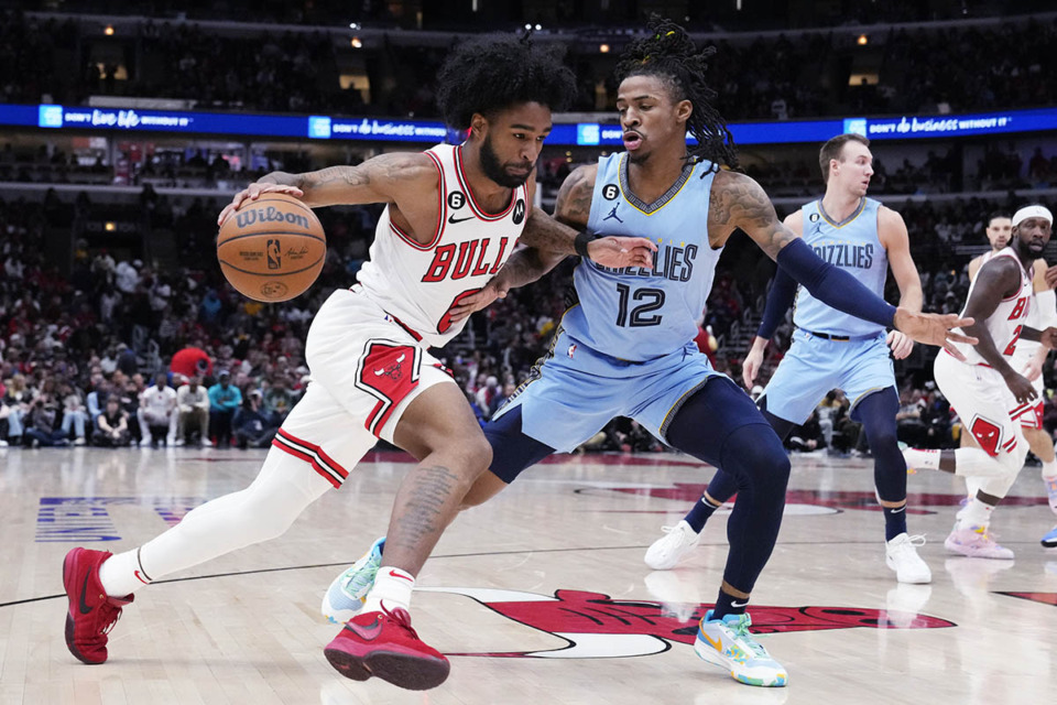 <strong>Chicago Bulls guard Coby White (left) drives as Memphis Grizzlies guard Ja Morant guards during the game in Chicago, Sunday, April 2, 2023.</strong> (Nam Y. Huh/AP Photo)