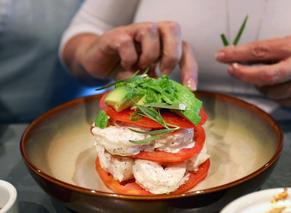 <strong>Restaurant Iris chef Kelly English puts the finishing touches on a shrimp, avocado and tomato salad on Monday, May 13, 2019.</strong> (Patrick Lantrip/Daily Memphian)