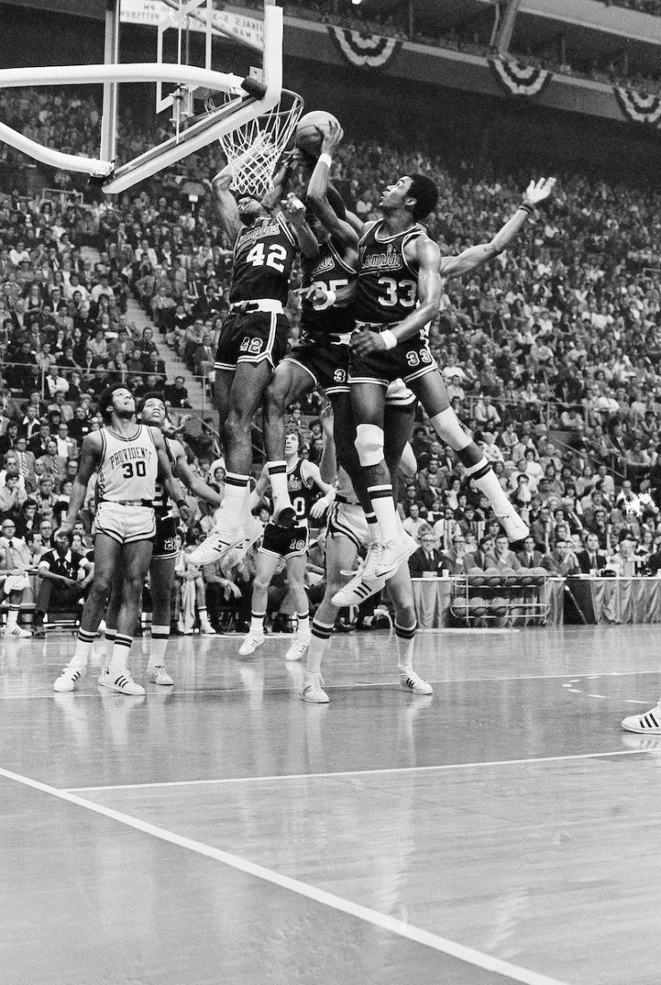 <strong>Three Memphis State University players, forward Wes Westfall (42), forward Larry Kenon (35) and center Ronnie Robinson (33) are hawking a rebound as the fashion a 98-85 win over Providence College in semi-final game of NCAA championship on March 26, 1973 in St. Louis. Memphis State will meet UCLA in finals Monday.</strong> (AP Photo)