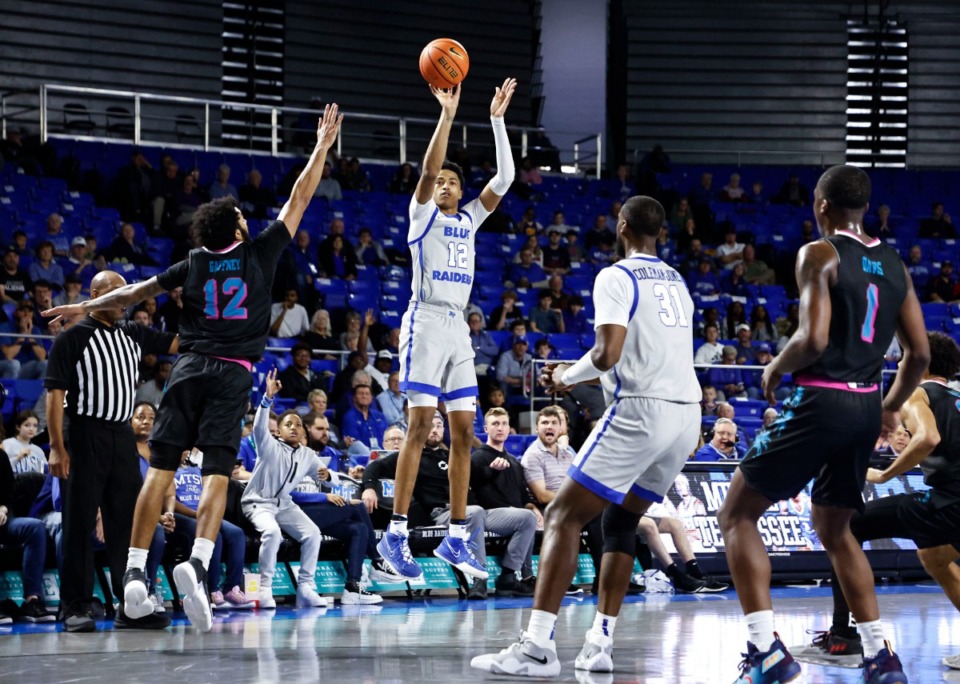<strong>Middle Tennessee guard Teafale Lenard Jr., middle, shoots past Florida Atlantic guard Jalen Gaffney, front left, during the second half of an NCAA college basketball game Feb. 16 in Murfreesboro.</strong> (Wade Payne/AP Photo file)