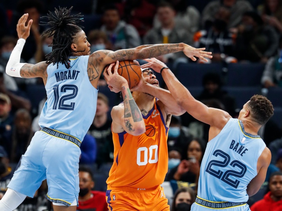 <strong>Memphis Grizzlies defender Ja Morant (left) blocks the shot of Phoenix Suns center JaVale McGee (middle) as teammate Desmond Bane (right) helps on the play during game action on Friday, Nov. 12, 2021.</strong> (Mark Weber/The Daily Memphian file)