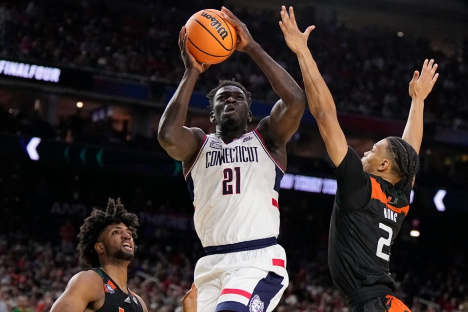 <strong>Connecticut forward Adama Sanogo scores past Miami guard Isaiah Wong during the second half of a Final Four college basketball game in the NCAA Tournament on Saturday, April 1, 2023, in Houston.</strong> (AP Photo/Brynn Anderson)