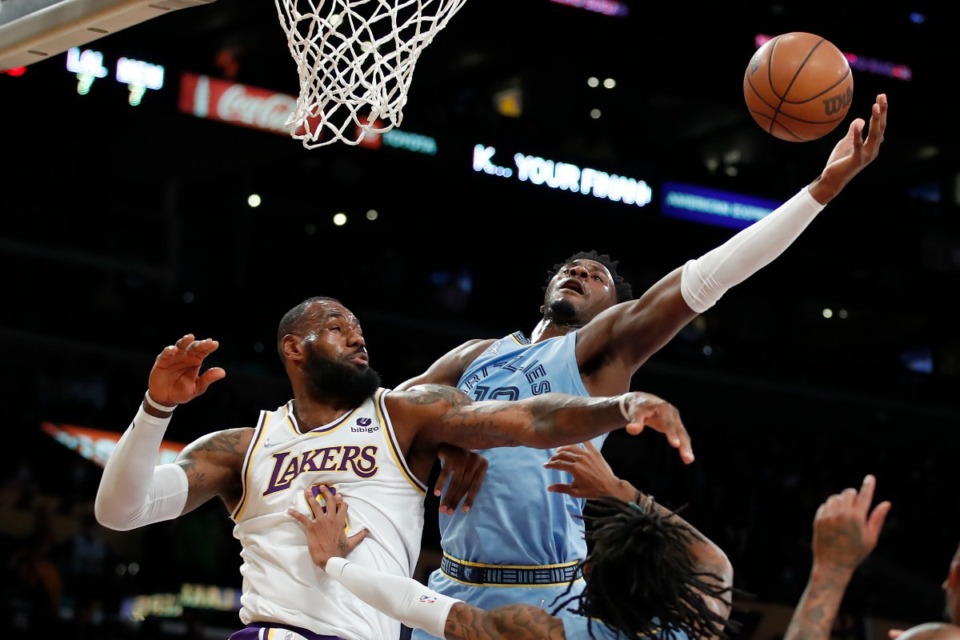 <strong>Memphis Grizzlies forward Jaren Jackson Jr., top right, vies for the ball with Los Angeles Lakers forward LeBron James, left, during the first half of an NBA basketball game Sunday, Jan. 9, 2022, in Los Angeles.</strong> (AP Photo/Alex Gallardo)