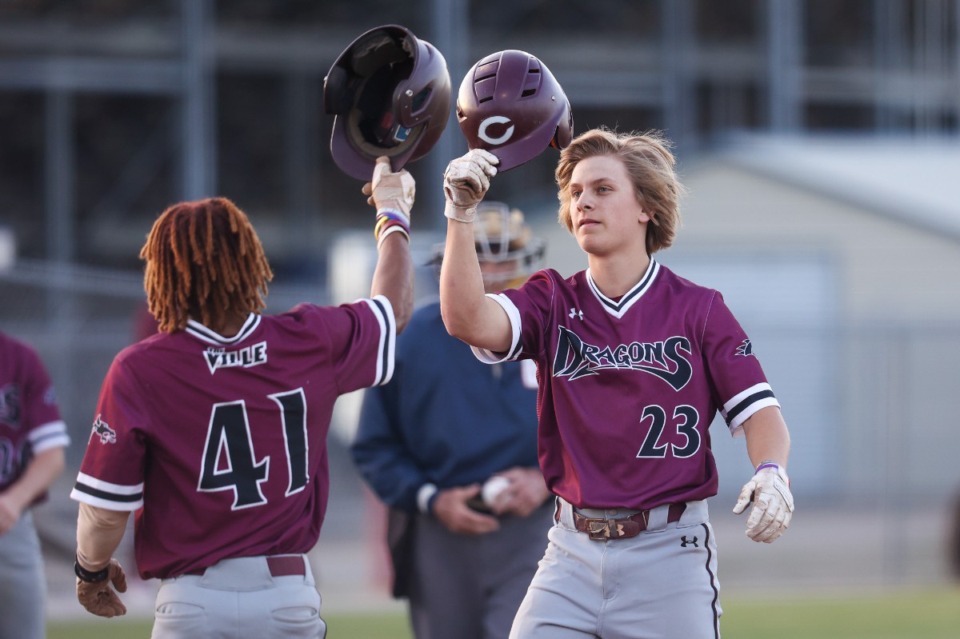 <strong>Collierville&rsquo;s DJ Whitworth (23) and Austin Smith (41) bump helmets after scoring runs against Arlington on April 18, 2023.</strong> (Ryan Beatty/Special to the Daily Memphian)