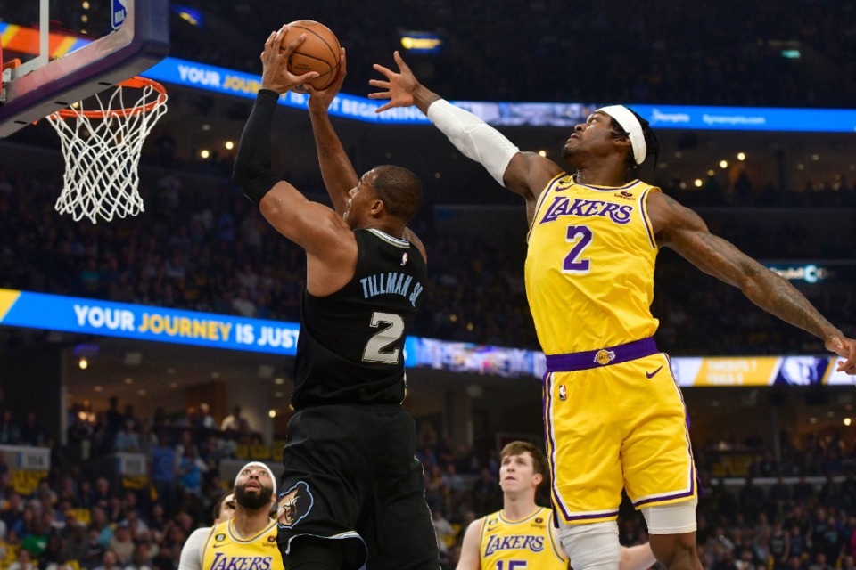 <strong>Memphis Grizzlies forward Xavier Tillman Sr. shoots next to Los Angeles Lakers forward Jarred Vanderbilt on April 19, 2023. Tillman led the Grizzlies with 22 points.</strong> (Brandon Dill/AP)