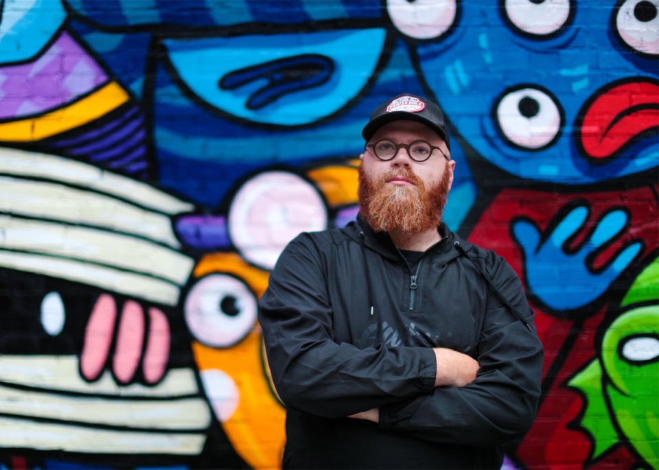<strong>Local artist Michael Roy, also known as Birdcap, in front of a mural he painted on the side of the Exchange Building in Downtown Memphis May 6, 2022.&nbsp;Roy&rsquo;s newest project,&nbsp;&ldquo;The Grief Manual,&rdquo; is a graphic novel written in the wake of his mother&rsquo;s death in 2020.</strong> (Patrick Lantrip/The Daily Memphian file)