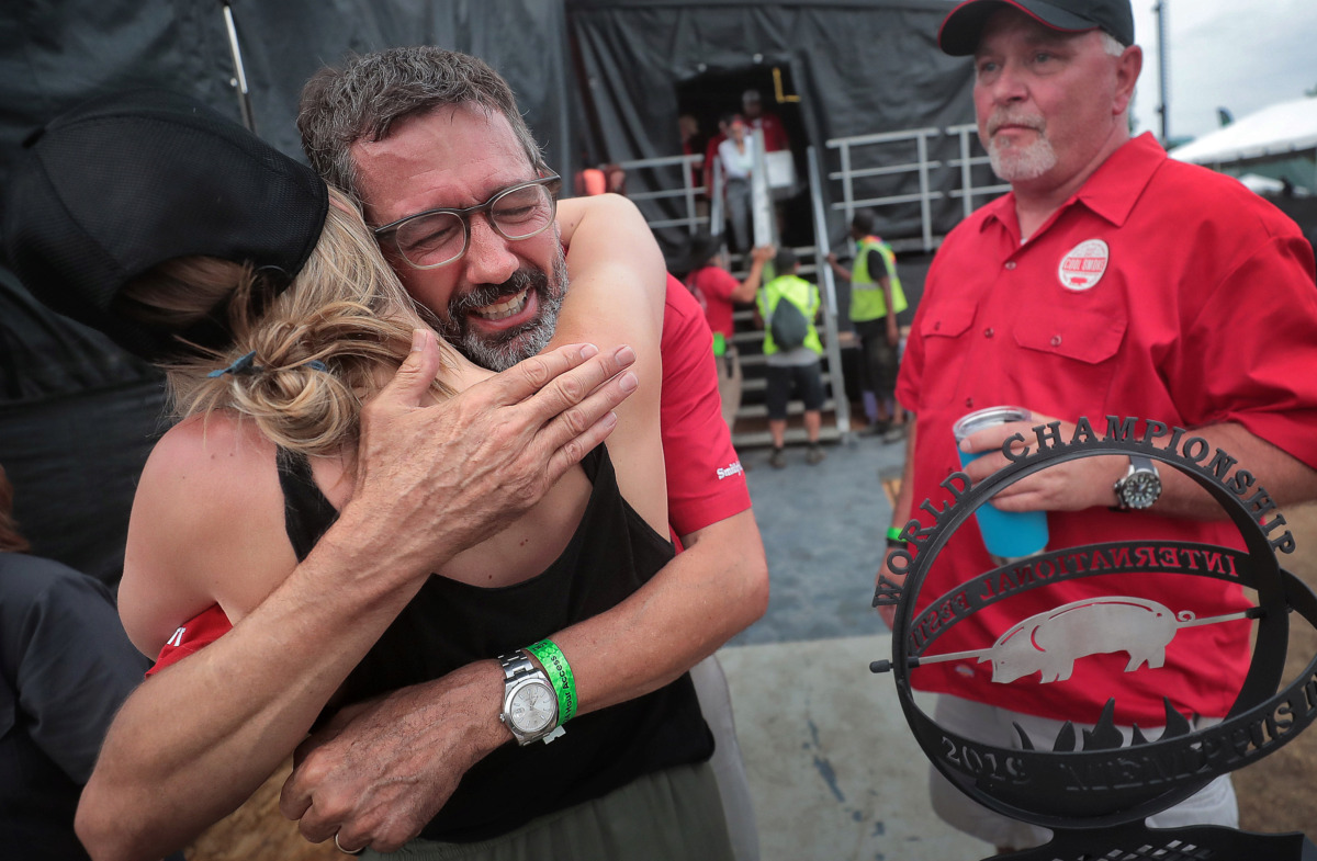 <strong>Pitmaster Tuffy Stone (center) tears up as he leaves the stage after his team, Cool Smoke, was named Grand Champion during the awards ceremony for the 2019 Memphis in May World Championship Barbecue Cooking Contest at Tom Lee Park on May, 18, 2019.</strong> (Jim Weber/Daily Memphian)